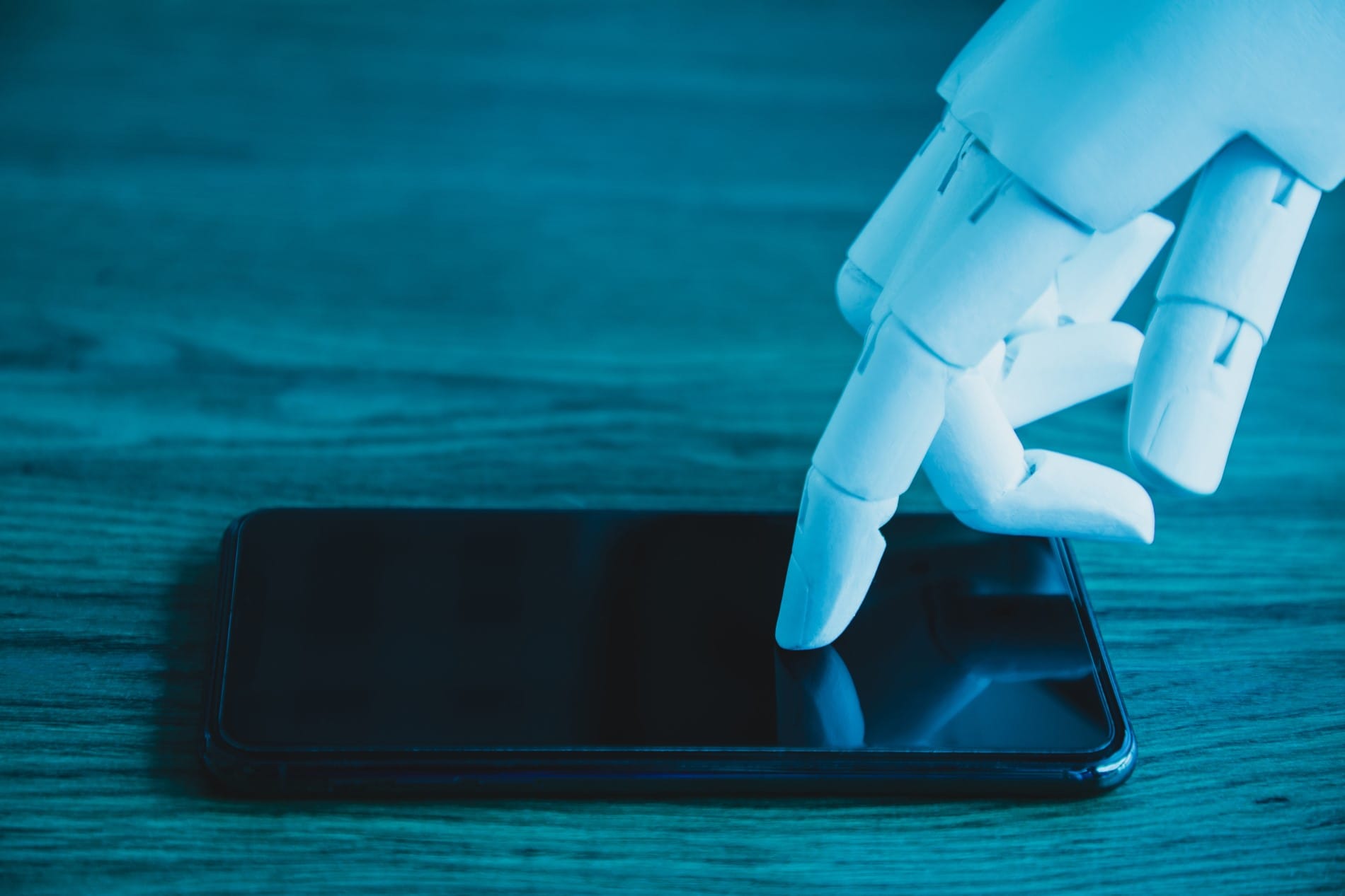Robot hand working on a phone.